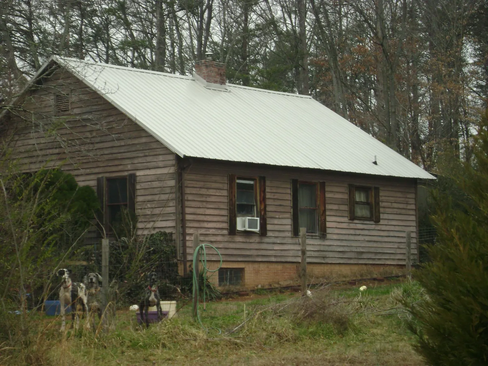 White metal roof on an old wood sided farmhouse, from a Metal Roof Installation job in Marengo